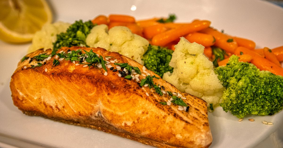 Delicious grilled salmon served with vibrant mixed vegetables, perfect for a healthy meal.