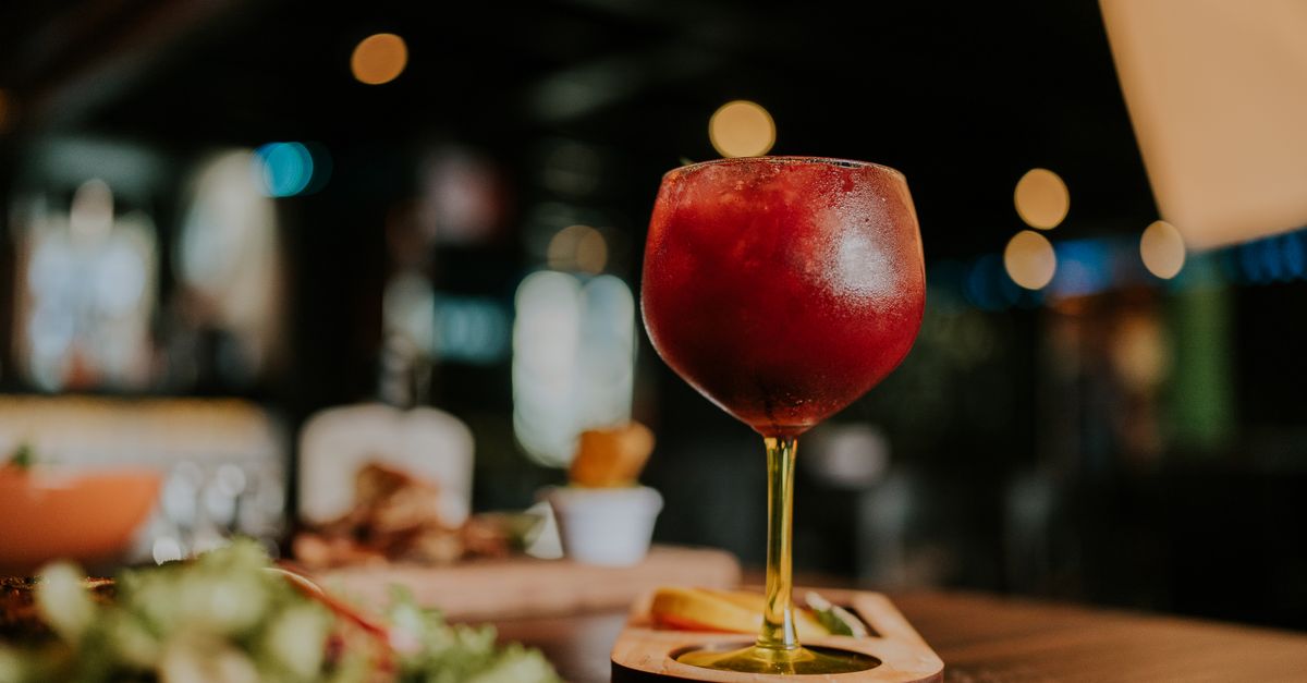 Refreshing chilled red cocktail in glass, perfect for a relaxing evening indoors.