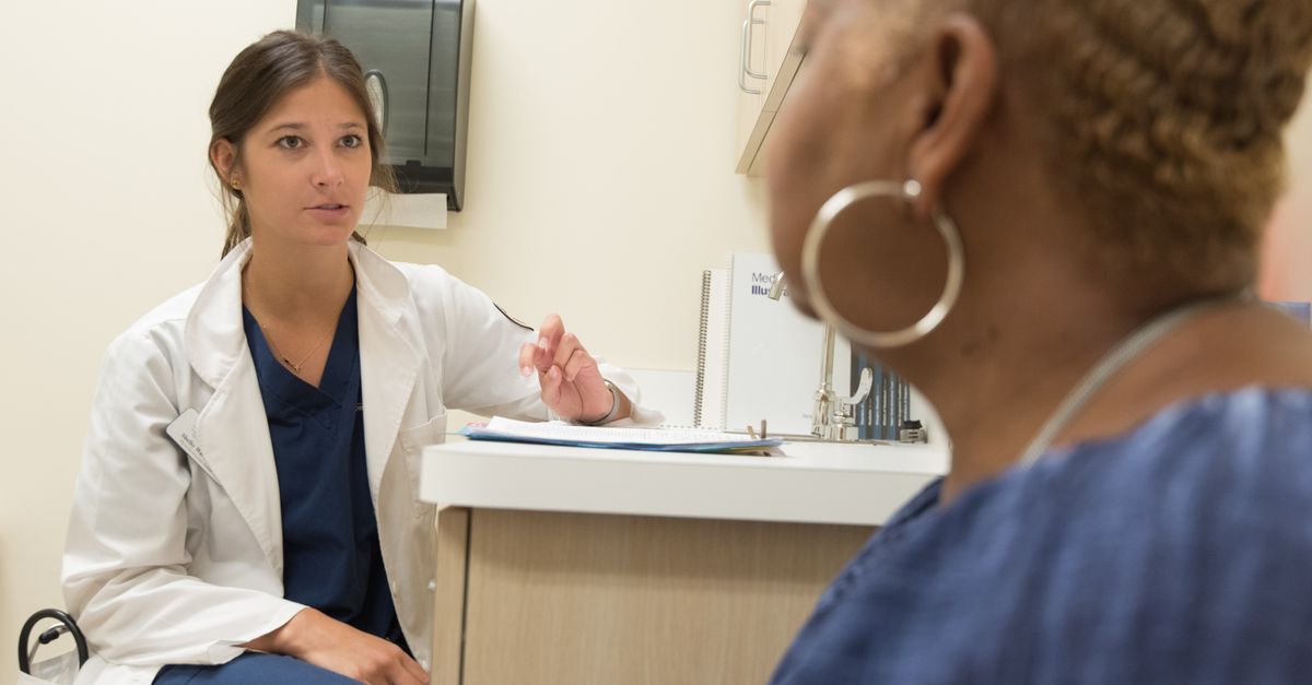 Doctor in consultation with patient at a medical clinic, discussing treatment options.